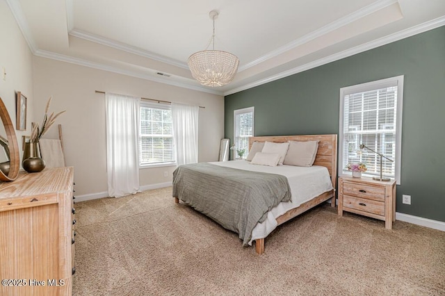 bedroom featuring a tray ceiling, ornamental molding, a chandelier, light carpet, and baseboards