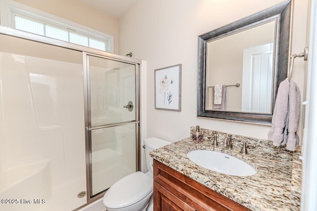 full bath with toilet, a stall shower, and vanity