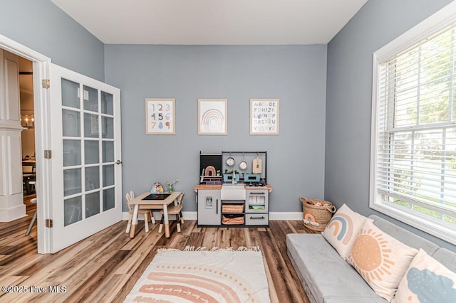 living area featuring wood finished floors and baseboards