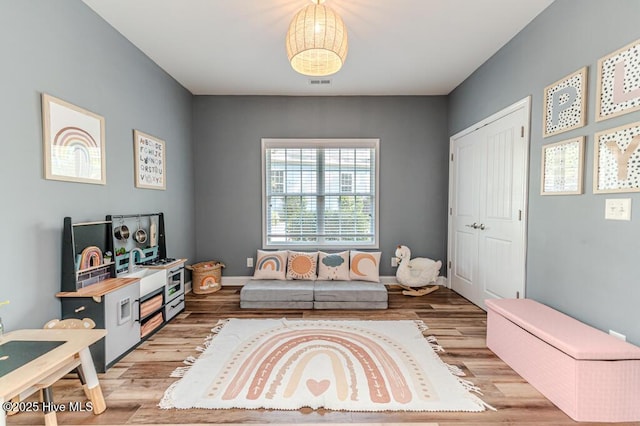 living area with light wood-style floors and baseboards
