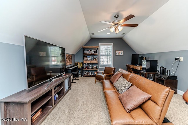 living area with carpet floors, ceiling fan, vaulted ceiling, and baseboards