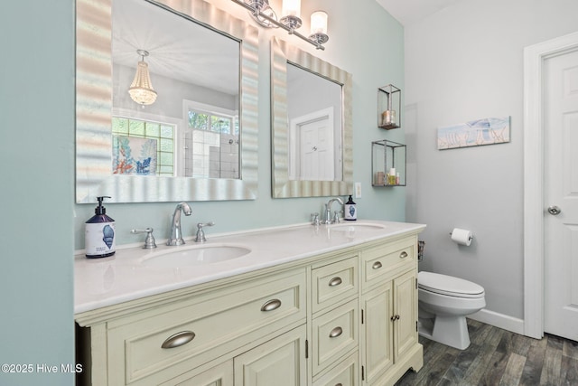4145 Brighton Ln, Southport, NC 28461 - full bath with a sink, double vanity, toilet, and wood finished floors