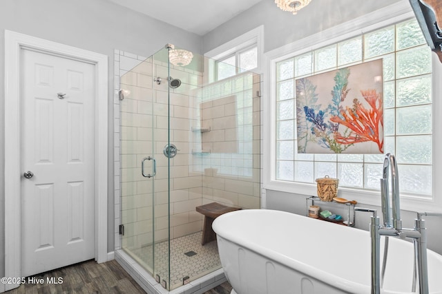 4145 Brighton Ln, Southport, NC 28461 - bathroom with a shower stall, a freestanding bath, and wood finished floors