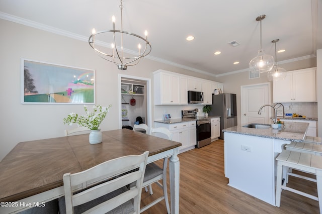 4524 Sweet Williams Ln NW, Wilson, NC 27896 - kitchen with appliances with stainless steel finishes, recessed lighting, a sink, a chandelier, and light wood-type flooring