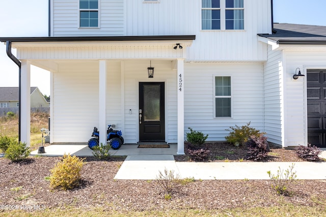 4524 Sweet Williams Ln NW, Wilson, NC 27896 - view of exterior entry featuring board and batten siding and covered porch