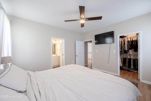 4524 Sweet Williams Ln NW, Wilson, NC 27896 - bedroom with wood finished floors, a ceiling fan, a closet, baseboards, and a spacious closet