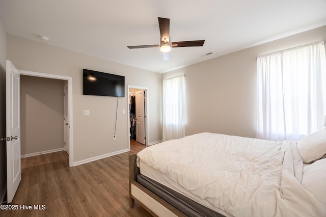 4524 Sweet Williams Ln NW, Wilson, NC 27896 - bedroom featuring wood finished floors, a closet, a walk in closet, visible vents, and baseboards