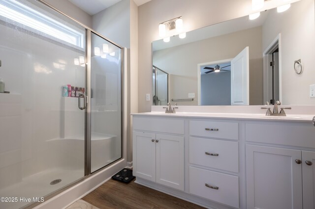 4524 Sweet Williams Ln NW, Wilson, NC 27896 - full bath featuring a sink, wood finished floors, a shower stall, a ceiling fan, and double vanity