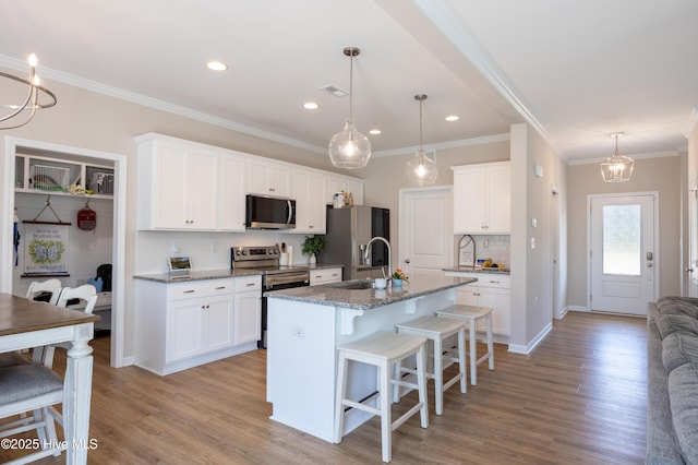 4524 Sweet Williams Ln NW, Wilson, NC 27896 - kitchen featuring visible vents, a sink, a kitchen breakfast bar, stainless steel appliances, and tasteful backsplash