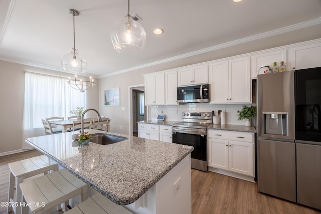 4524 Sweet Williams Ln NW, Wilson, NC 27896 - kitchen featuring a sink, ornamental molding, a kitchen island with sink, white cabinetry, and appliances with stainless steel finishes