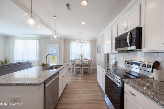 4524 Sweet Williams Ln NW, Wilson, NC 27896 - kitchen with a sink, stainless steel appliances, white cabinetry, light wood-type flooring, and visible vents