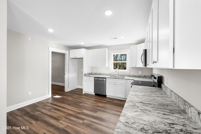 1191 Pierce Rd, Southport, NC 28461 - kitchen with dark wood finished floors, white cabinetry, appliances with stainless steel finishes, and a sink