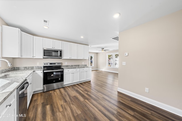 1191 Pierce Rd, Southport, NC 28461 - kitchen with dark wood-style flooring, visible vents, a sink, white cabinetry, and stainless steel appliances