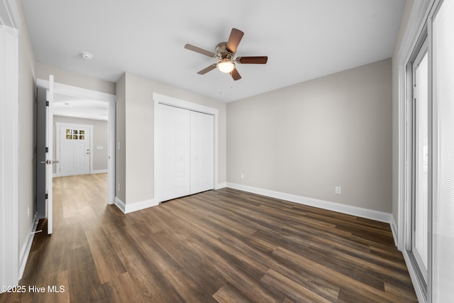 1191 Pierce Rd, Southport, NC 28461 - unfurnished bedroom featuring a ceiling fan, baseboards, dark wood-style floors, and a closet