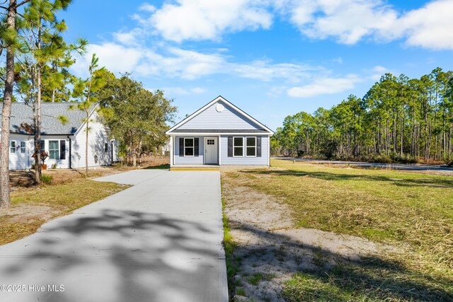 1191 Pierce Rd, Southport, NC 28461 - bungalow-style house with driveway and a front lawn