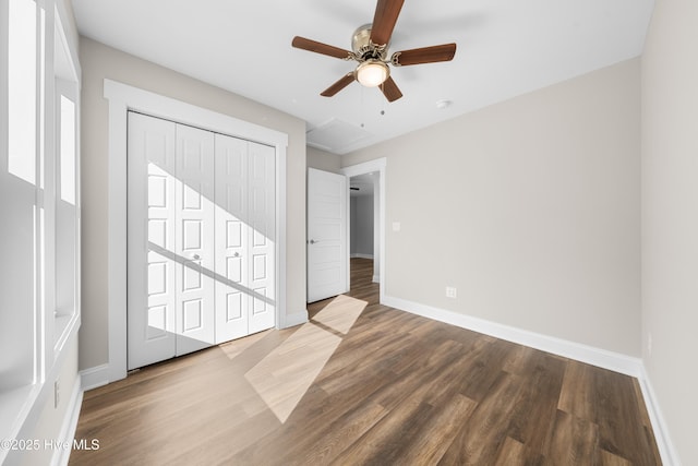 1191 Pierce Rd, Southport, NC 28461 - unfurnished bedroom featuring baseboards, a closet, a ceiling fan, and wood finished floors