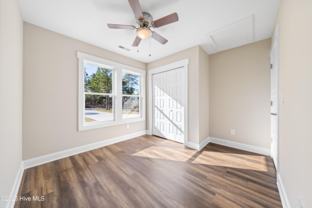 1191 Pierce Rd, Southport, NC 28461 - unfurnished bedroom with a closet, wood finished floors, attic access, visible vents, and baseboards