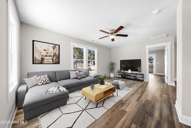 1191 Pierce Rd, Southport, NC 28461 - living room featuring baseboards, visible vents, wood finished floors, and a ceiling fan