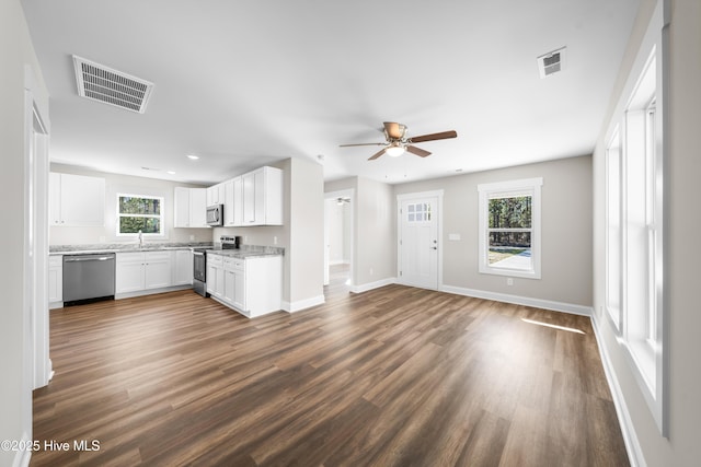1191 Pierce Rd, Southport, NC 28461 - unfurnished living room with a sink, visible vents, dark wood-style flooring, baseboards, and ceiling fan