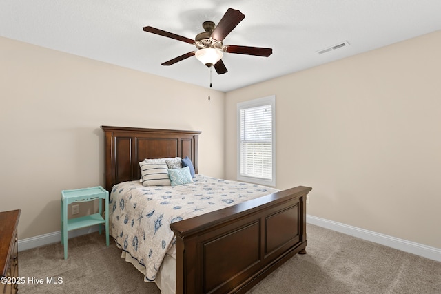 bedroom featuring light colored carpet, baseboards, and ceiling fan