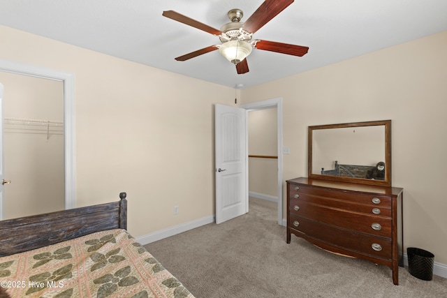 bedroom with carpet, baseboards, a closet, and a ceiling fan