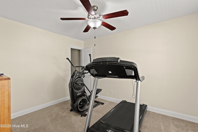 exercise room with carpet flooring, a ceiling fan, and baseboards