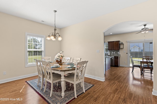 324 Catamaran Rd, Swansboro, NC 28584 - dining space featuring arched walkways, dark wood-style floors, ceiling fan, baseboards, and a chandelier