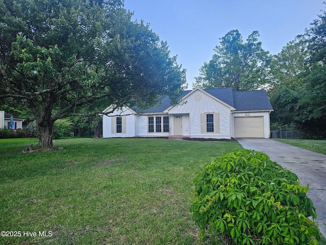 ranch-style house featuring an attached garage, driveway, and a front lawn