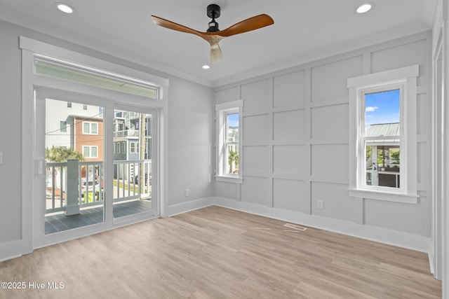 unfurnished room with light wood-style flooring, a ceiling fan, baseboards, a decorative wall, and recessed lighting