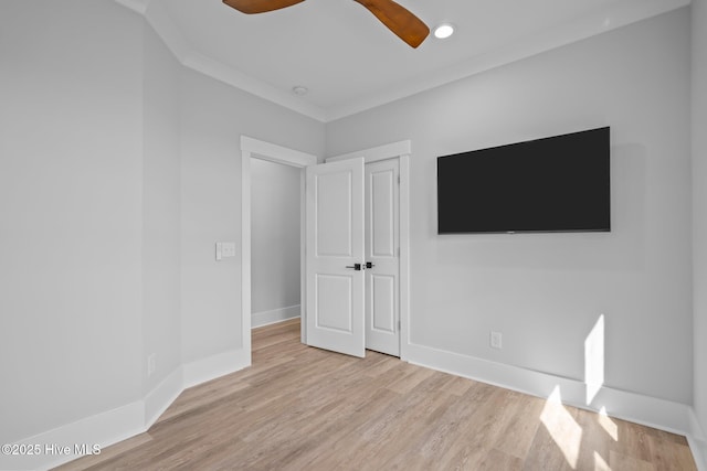 unfurnished bedroom with baseboards, a ceiling fan, and wood finished floors