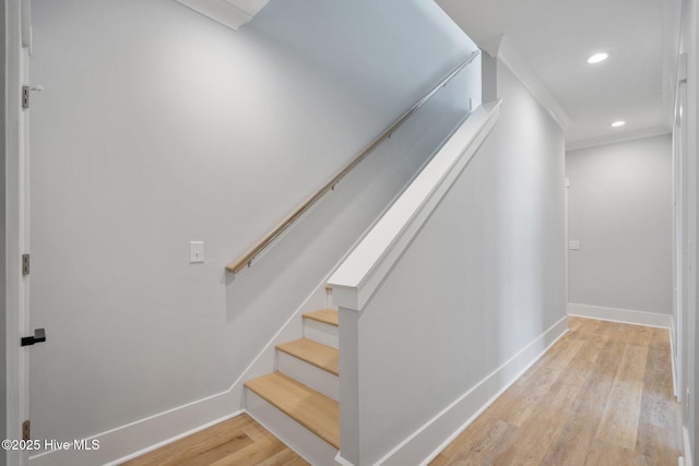 staircase with baseboards, recessed lighting, and wood finished floors