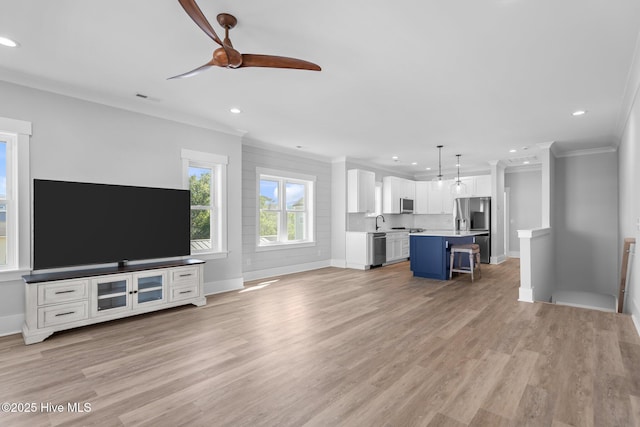 unfurnished living room with crown molding, baseboards, ceiling fan, and recessed lighting