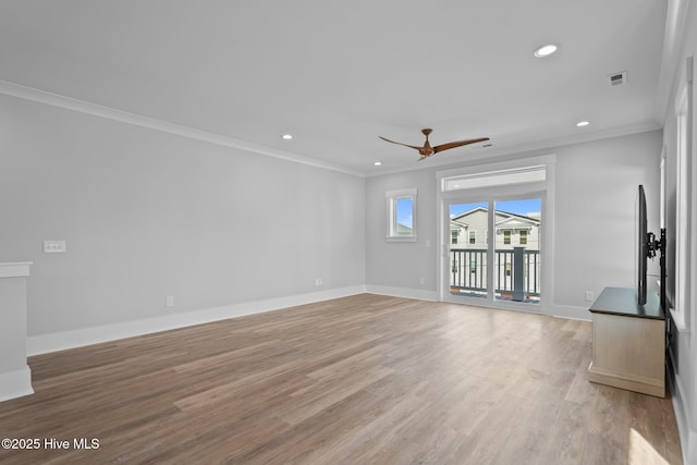unfurnished living room with crown molding, visible vents, light wood-style flooring, and a ceiling fan