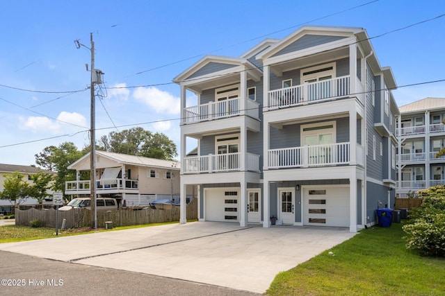 coastal home with central air condition unit, fence, an attached garage, driveway, and a front yard