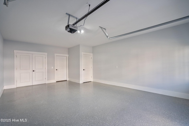 garage with baseboards and a garage door opener