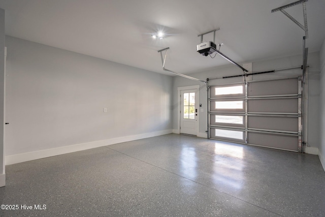 garage with baseboards and a garage door opener