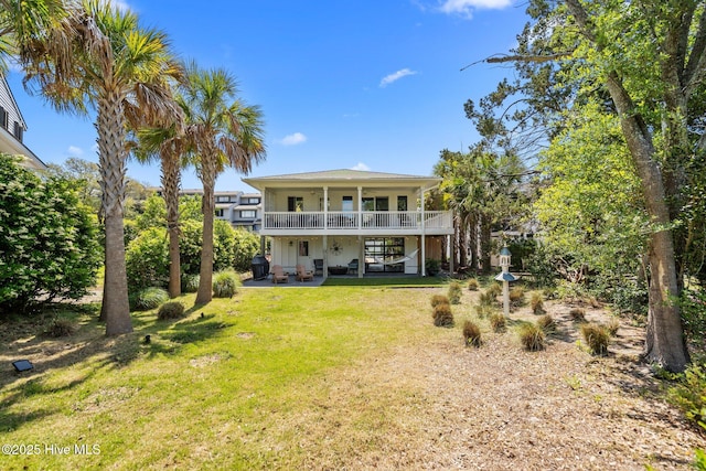 rear view of house with a yard and a patio area