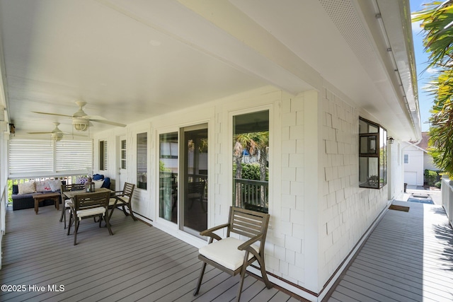 wooden terrace featuring an outdoor hangout area and ceiling fan