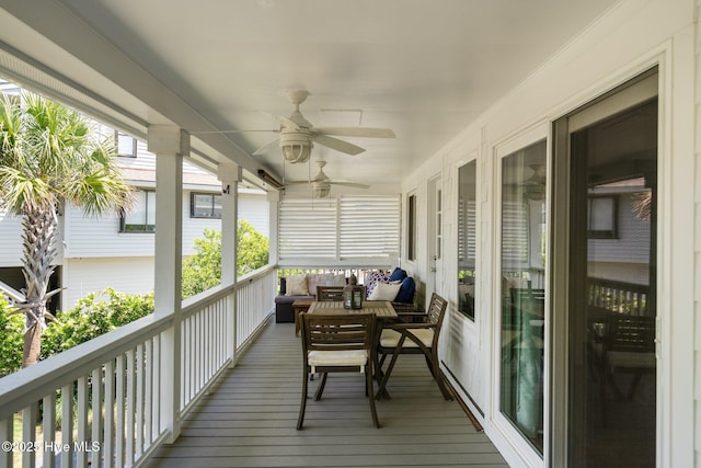 sunroom featuring a ceiling fan and an outdoor hangout area