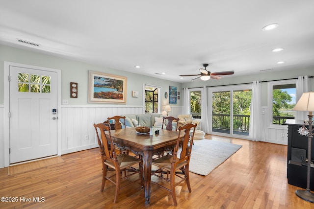 dining room featuring a wainscoted wall, healthy amount of natural light, recessed lighting, ceiling fan, and light wood-type flooring