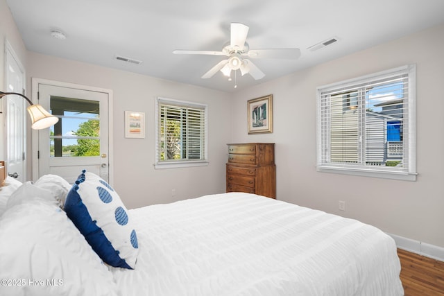 bedroom with wood finished floors, baseboards, and a ceiling fan