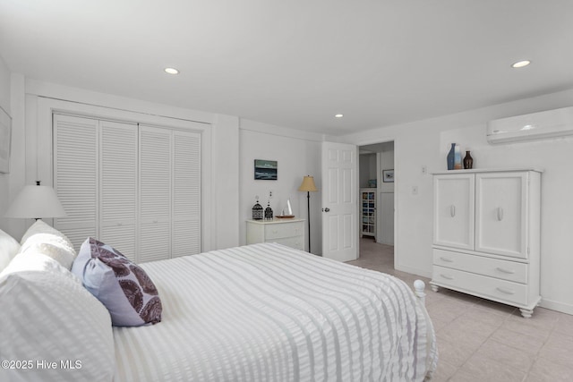 bedroom with a wall unit AC, a closet, recessed lighting, light tile patterned floors, and baseboards