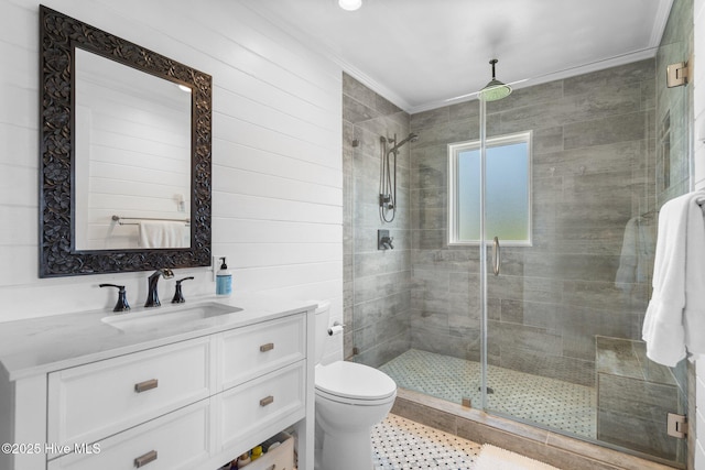 full bathroom featuring a shower stall, crown molding, toilet, vanity, and tile patterned floors