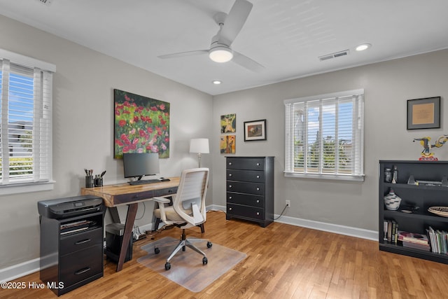 office featuring healthy amount of natural light, wood finished floors, baseboards, and recessed lighting