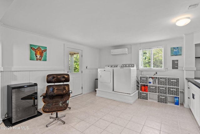 laundry room featuring separate washer and dryer, a wall unit AC, healthy amount of natural light, electric panel, and a wainscoted wall
