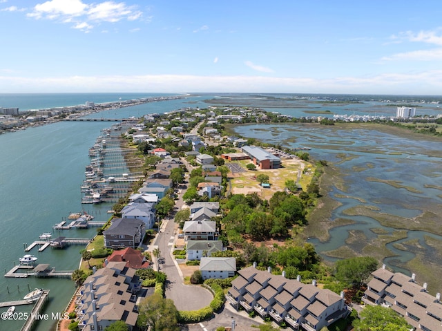view of property location featuring a nearby body of water and nearby suburban area