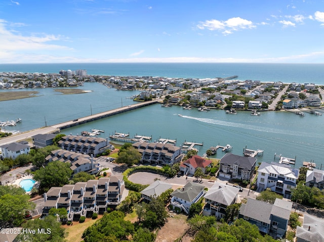 aerial perspective of suburban area with a nearby body of water