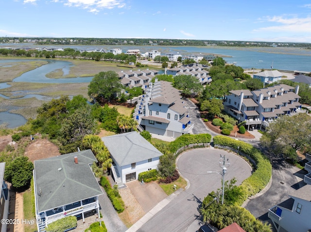 aerial view of residential area featuring a large body of water