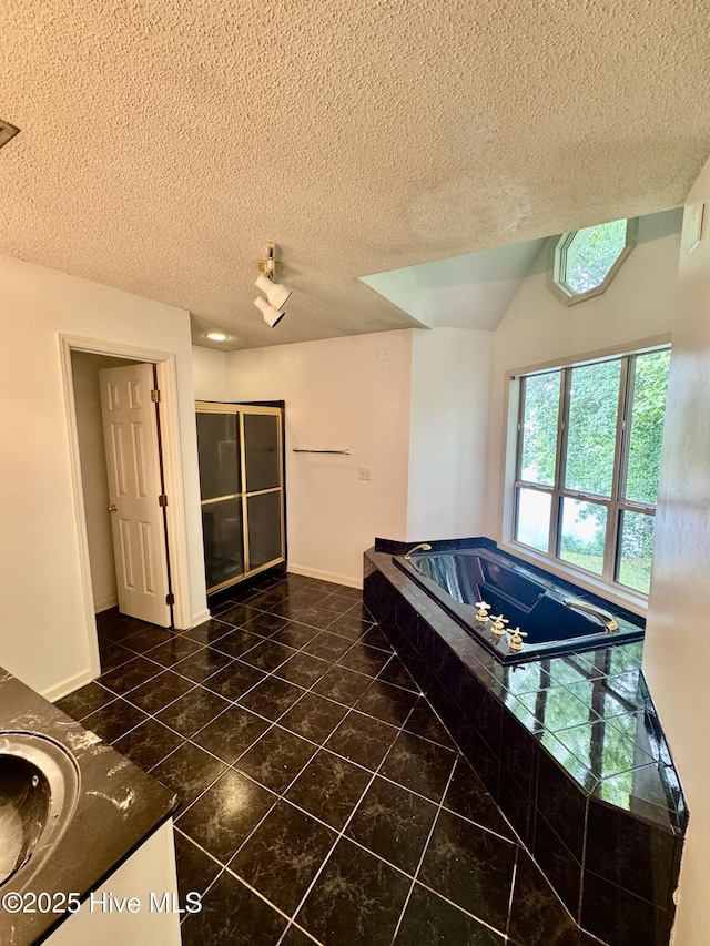 607 Spring Forest Rd Unit G, Greenville, NC 27834 - interior space featuring tile patterned floors, a textured ceiling, baseboards, and a garden tub