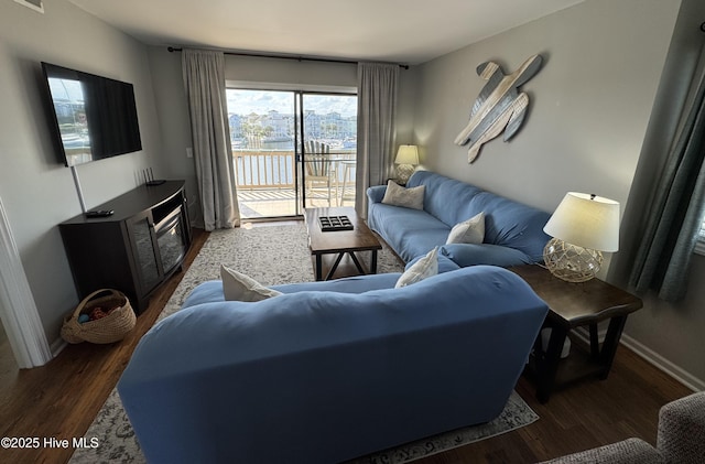 living room featuring wood finished floors and baseboards